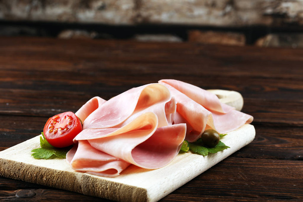 Sliced ham on wooden background. Fresh prosciutto cotto. Tasty P - Photo, Image