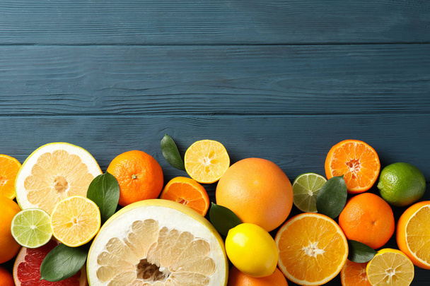 Juicy citrus fruits on wooden background, space for text - Fotografie, Obrázek