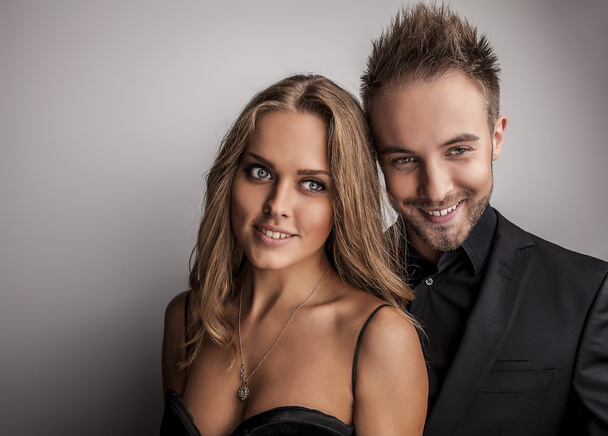 Portrait of young attractive couple posing at studio dressed in black fashionable clothes. - Foto, immagini