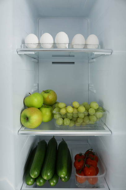 Open refrigerator full of different fresh products - Foto, immagini