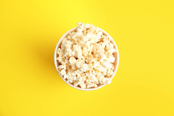 Tasty pop corn on yellow background, top view - Photo, Image