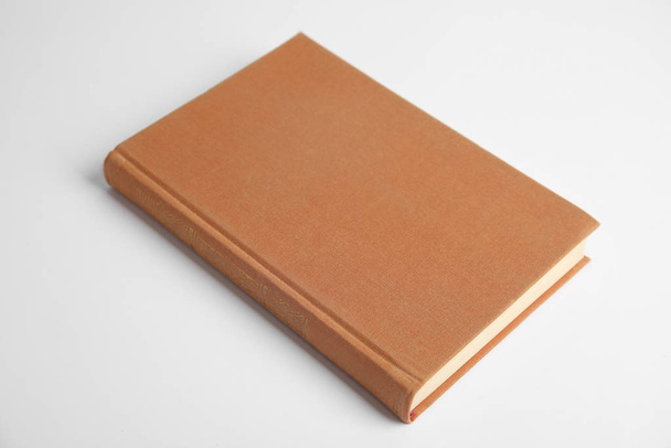Hardcover book on white background. Space for design - 写真・画像