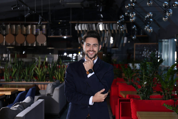 Young business owner standing in his cafe - Foto, imagen