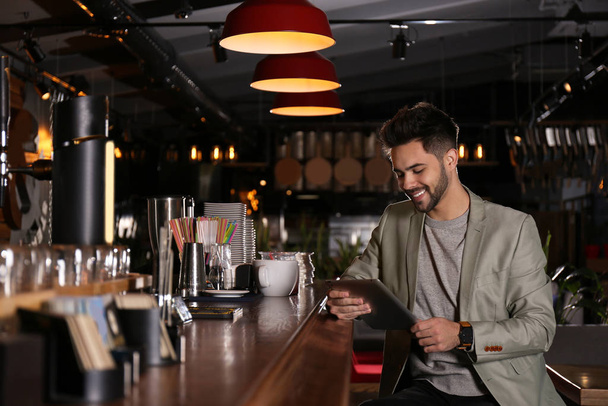 Young business owner with tablet in his cafe - Photo, Image