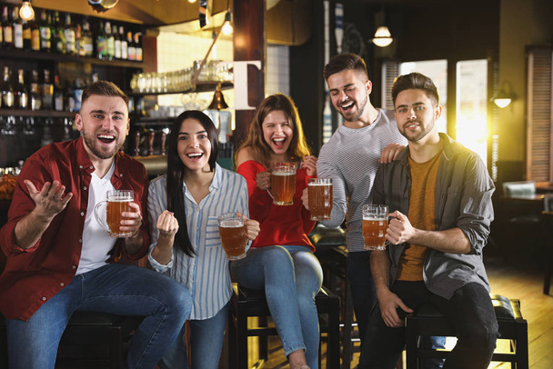 Group of friends watching football in sport bar - Photo, Image