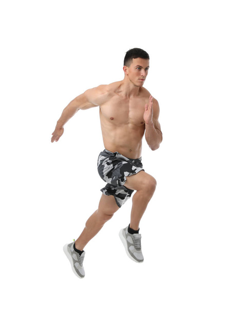 Athletic young man running on white background - 写真・画像