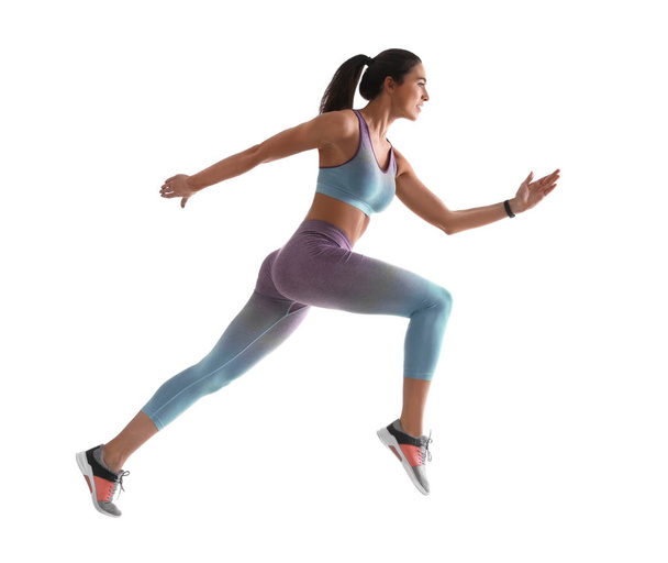 Athletic young woman running on white background, side view - Foto, immagini