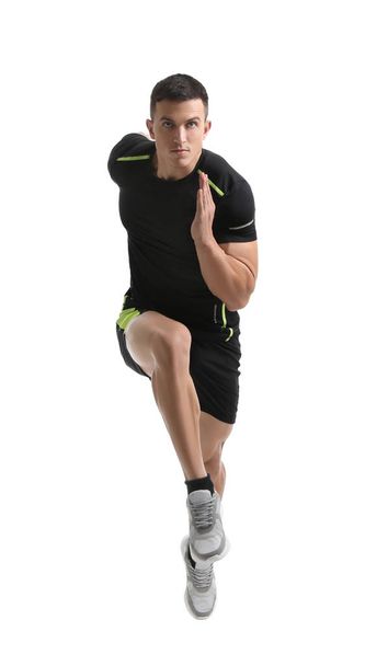 Athletic young man running on white background - Foto, Imagen