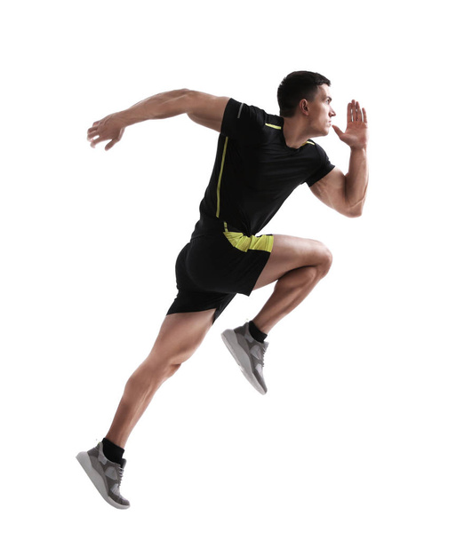 Athletic young man running on white background, side view - 写真・画像