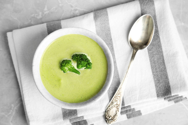 Delicious broccoli cream soup served on grey marble table, top view - Photo, Image