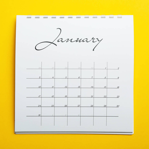 January calendar on yellow background, top view - Foto, afbeelding