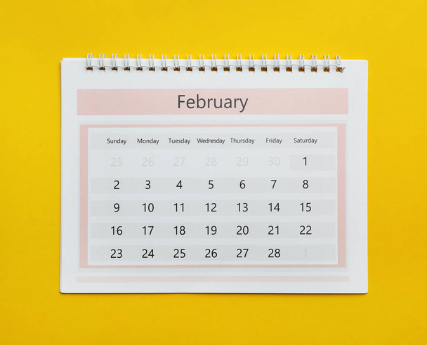 February calendar on yellow background, top view - Photo, Image