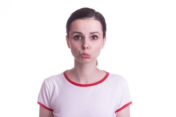 attractive emotional girl in a red and white t-shirt on a white background - Zdjęcie, obraz