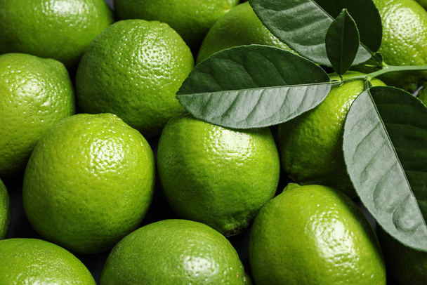 Fresh ripe green limes as background, closeup - Zdjęcie, obraz
