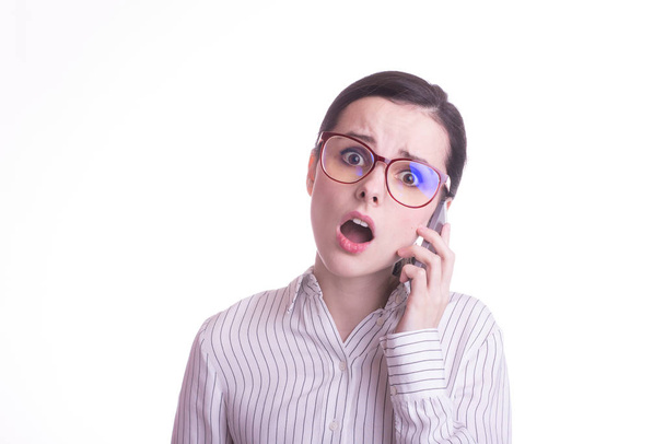 beautiful girl in glasses and a shirt speaks on the phone - 写真・画像