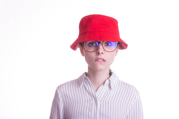 beautiful girl in glasses for vision, a shirt and a red panama, on a white background - Fotografie, Obrázek