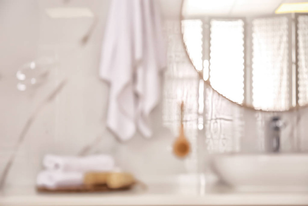 Blurred view of stylish modern bathroom with mirror - Foto, Imagen
