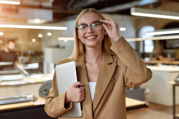 A day starts with you. Cheerful businesswoman posing in office - Фото, зображення