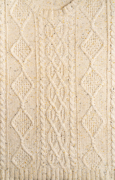 The texture of a knitted beige sweater. - 写真・画像