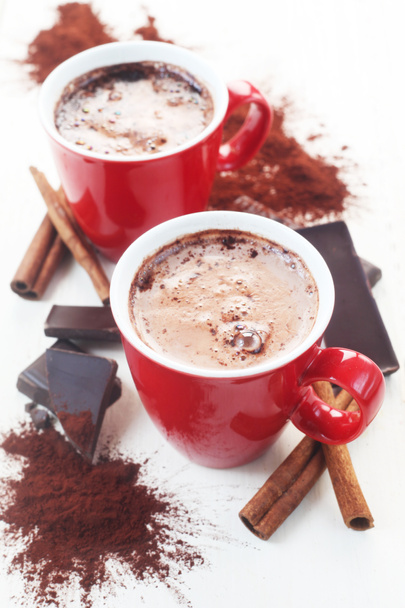 cups with hot chocolate and spices isolated on white - 写真・画像