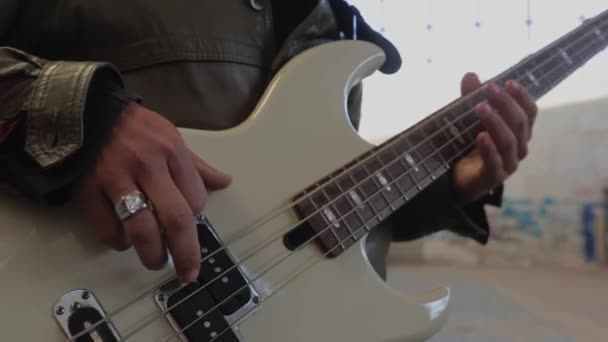 The guy plays an electric bass guitar. - Footage, Video