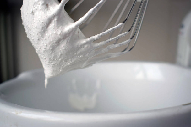 Whisk for mixer with sugar white icing. Cooking creams using a kitchen cobmine and a whisk nozzle. - Photo, Image