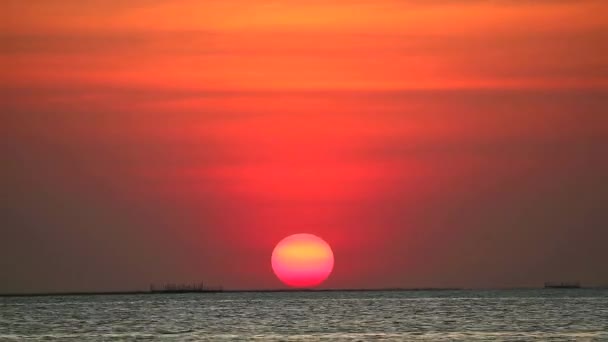 naplemente a vörös tiszta égen világos narancs felhő a tengeren - Felvétel, videó