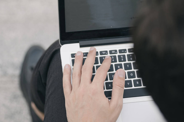 cropped image of hands using laptop with blank white screen - Zdjęcie, obraz