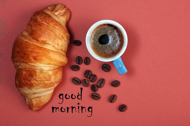 croissant and cup of coffee. croissant and coffee on a bright colorful background. top view. copy spaces - 写真・画像