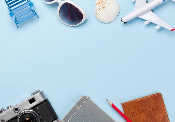 Travel concept with airplane, passport, camera and sunglasses. Top view flat lay with copy space - 写真・画像