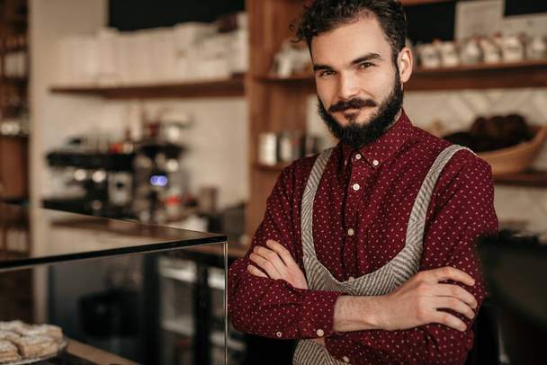 Confident bartender in cozy cafe - Фото, изображение