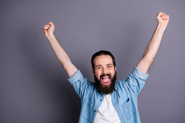 Yeah we win. Active football lover guy watch match his favorite team victory feel delighted crazy emotions raise fists scream yeah wear stylish clothes isolated over grey color background - Fotoğraf, Görsel