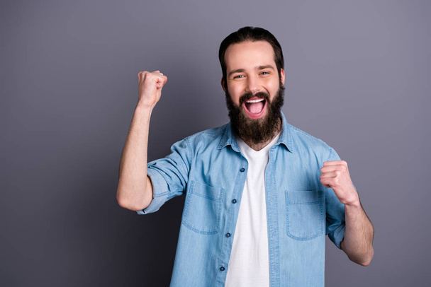 Portrait of ecstatic guy win lottery jackpot raise fists scream yeah wear good look clothes isolated over grey color background - Fotoğraf, Görsel