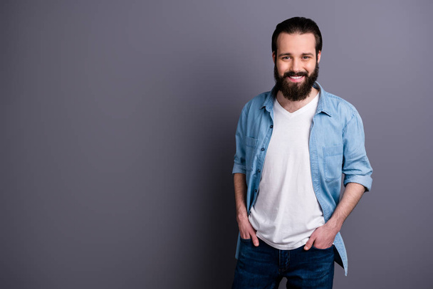 Portrait of charismatic enthusiastic guy relax rest free spring time put hands pockets wear stylish clothes isolated over grey color background - Foto, immagini
