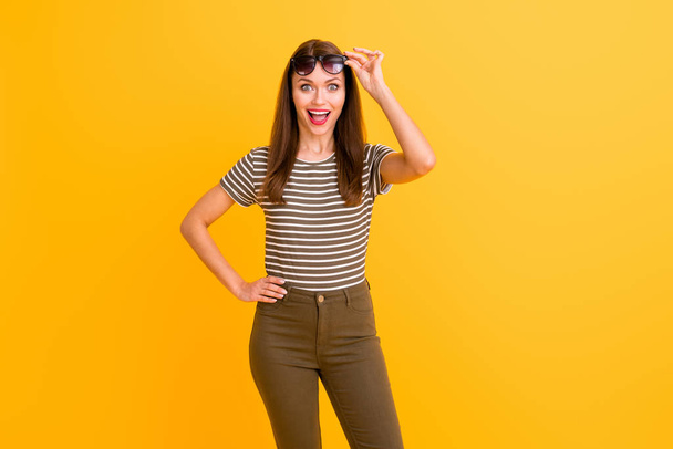 Portrait of impressed funky crazy girl have spring vacation look incredible black friday bargains touch her spectacles wear casual style outfit isolated over bright color background - 写真・画像