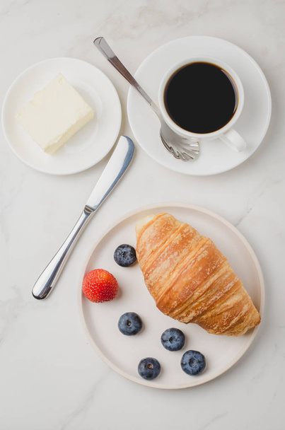 Delicious breakfast with fresh coffee, fresh croissants and berr - Photo, image