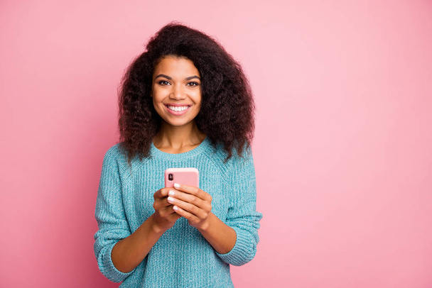 Photo of cheerful toothy beaming cute nice pretty woman holding telephone browsing social media working as smm manager isolated pastel color background - Φωτογραφία, εικόνα