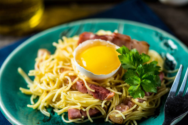pasta carbonara. Ham and cheese. Delicious spaghetti. Egg yolk. Italian cuisine. Traditional italian dish. - Photo, Image