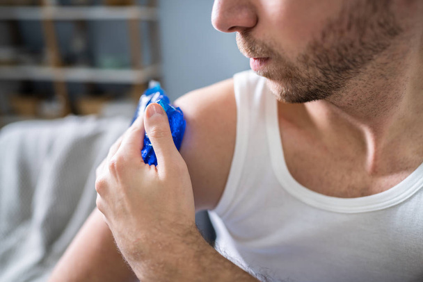 Close-up Of A Man Applying Cool Gel Pack On His Shoulder - Photo, Image
