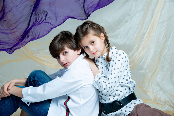 cute kids boy and girl posing in studio on gray background - Fotoğraf, Görsel