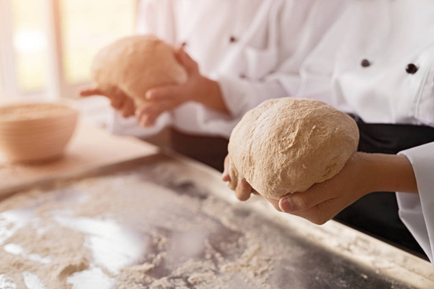 Crop bakers kneading soft dough - Zdjęcie, obraz