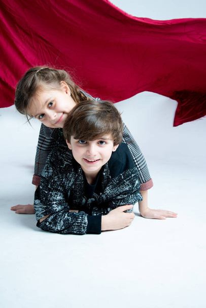 children posing at photo studio on gray background - Фото, зображення