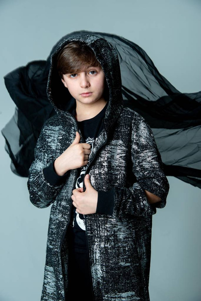 kid boy posing in photo studio on dark background - Фото, изображение