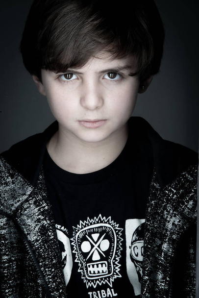 boy studio close up portrait in black zip hoodie on gray background - Foto, Imagem