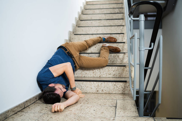 Unconscious Man Lying On Staircase After Slip And Fall Accident - Photo, Image