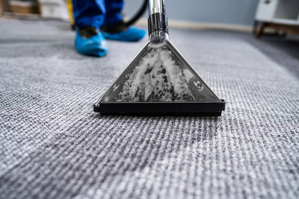 Close-up Of A Cleaning Carpet With Vacuum Cleaner - Фото, зображення