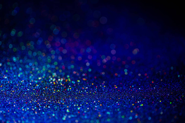 Classic blue color of the year 2020. Bokeh lights with bright shiny effect. Overlapping glowing and twinkling spots decorative backdrop. Abstract glittering circles. - Φωτογραφία, εικόνα