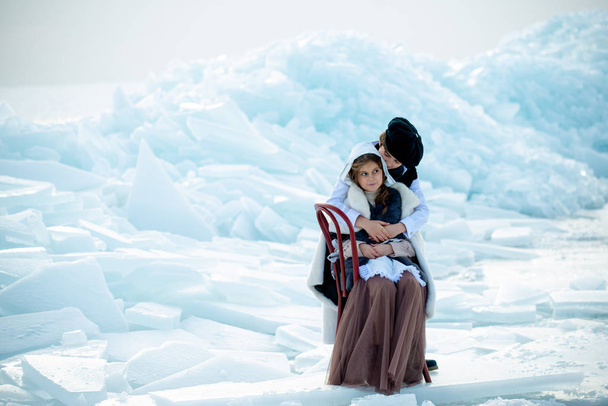 cute children in themed costumes hugging on iceberg on winter background - Φωτογραφία, εικόνα