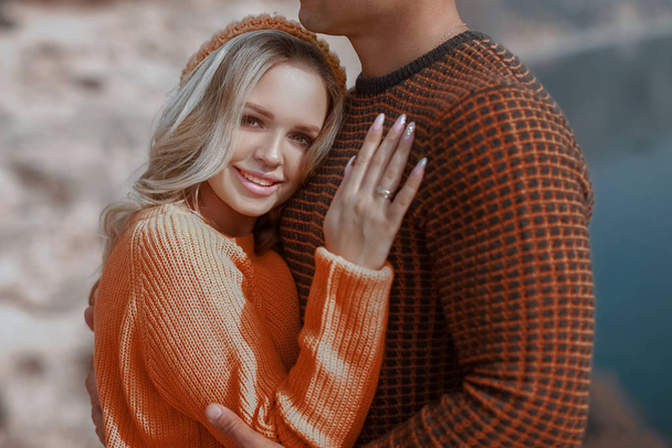 Portrait of a man with a woman in yellow warm sweaters - Photo, Image