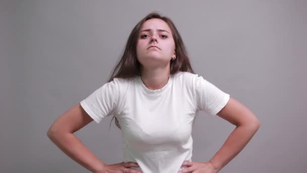 Disappointed brunette lady in fashion white shirt covered mouth with hands - Filmmaterial, Video